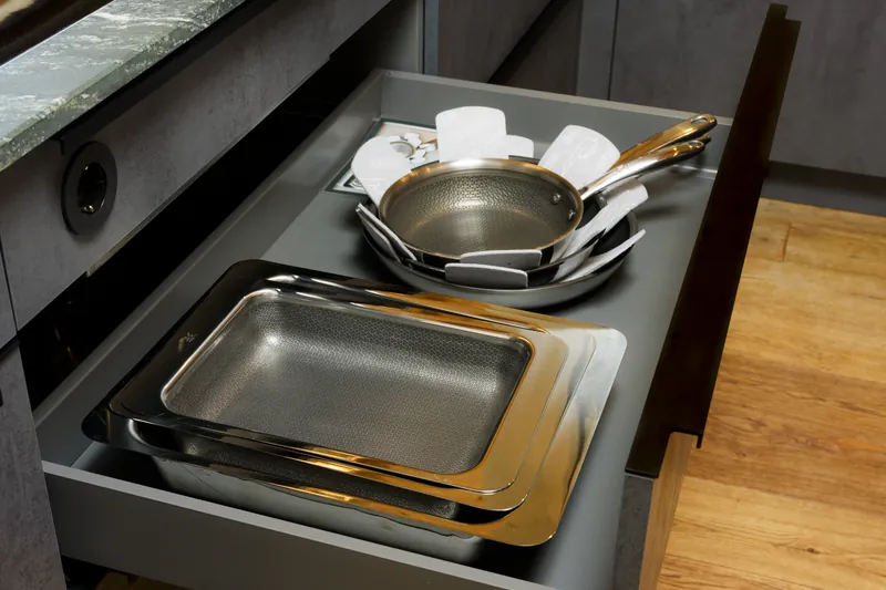 Kitchen drawer with stainless-steel frying pans and rectangular baking dishes